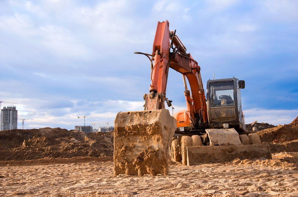 An Excavator is Moving Dirt on a Construction Site — Bennettron Demex in Kempsey, NSW