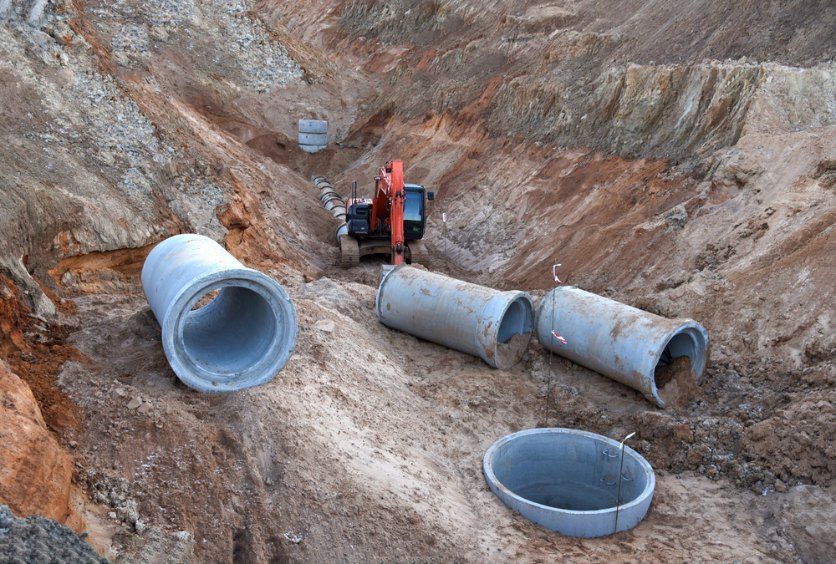 A Construction Site With Concrete Pipes and a Bulldozer in the Background — Bennettron Demex in Lennox Head, NSW