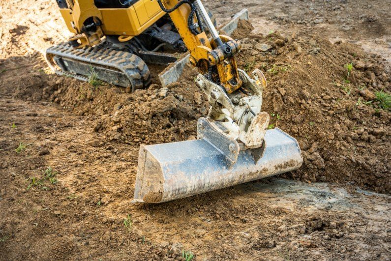 A Small Excavator is Digging a Hole in the Dirt — Bennettron Demex in Ballina, NSW