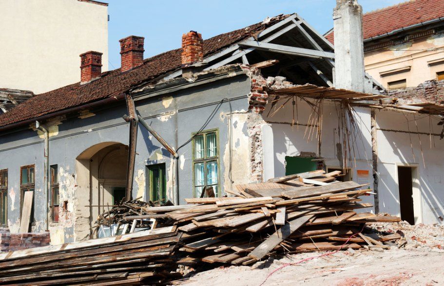 A Pile of Wood is in Front of a Building That is Being Demolished — Bennettron Demex in Lennox Head, NSW