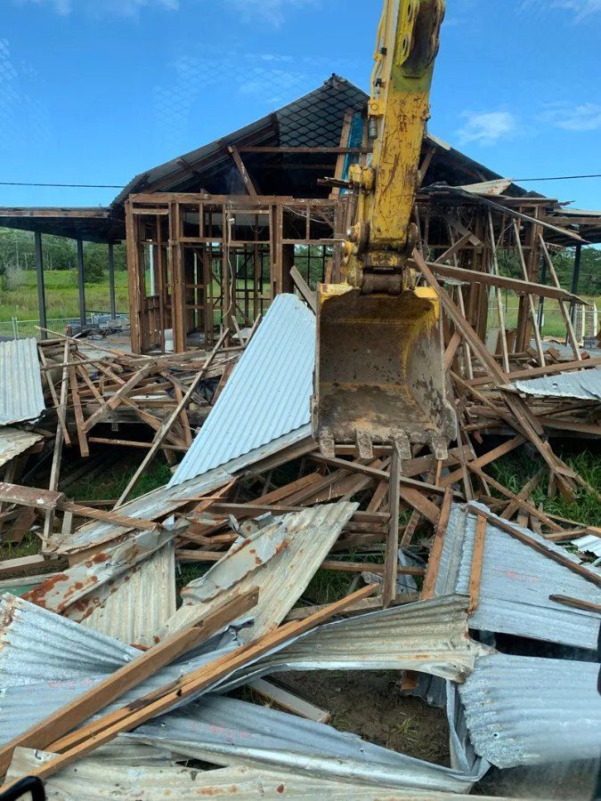 A House is Being Demolished by a Bulldozer — Bennettron Demex in Corindi Beach, NSW