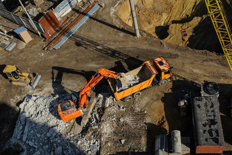 An aerial view of a construction site with a dump truck and an excavator. — Bennettron Demex in Corindi Beach, NSW