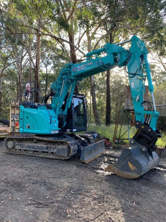 A Blue Excavator is Parked in a Dirt Lot in the Woods — Bennettron Demex in Tenterfield, NSW