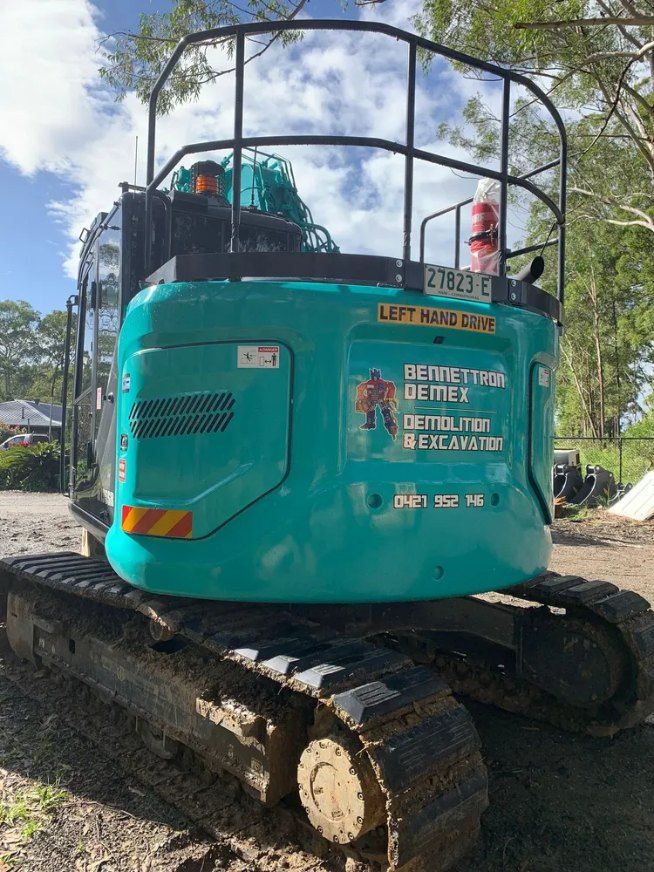 A Blue Excavator is Parked on the Side of a Dirt Road — Bennettron Demex in Corindi Beach, NSW