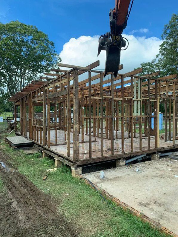 A Crane is Lifting a Wooden Structure in a Field — Bennettron Demex in Macksville, NSW