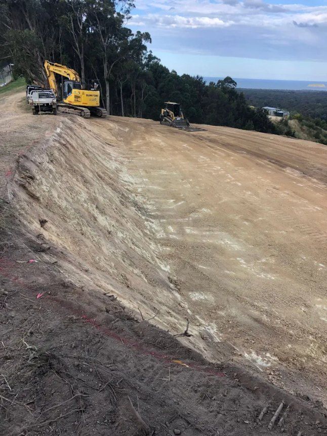 A Yellow Excavator is Sitting on Top of a Dirt Hill — Bennettron Demex in Tenterfield, NSW