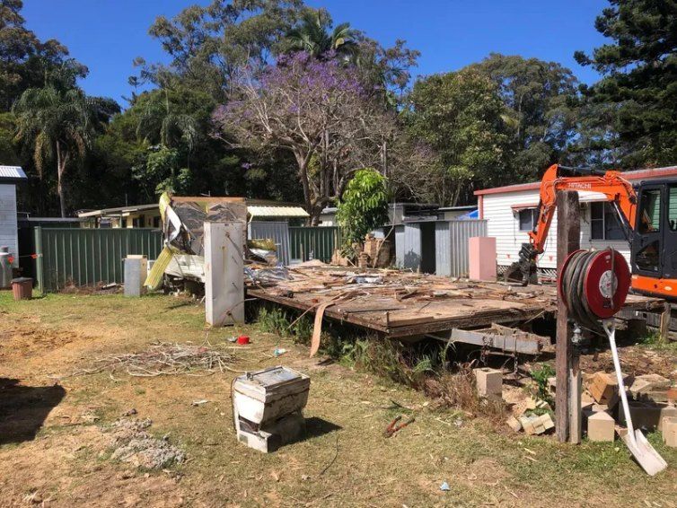 A House is Being Demolished in a Backyard With an Excavator — Bennettron Demex in Corindi Beach, NSW