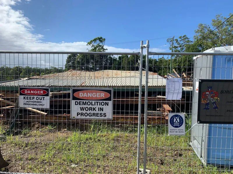 A Fence With a Danger Sign and a Demolition Work in Progress Sign on It — Bennettron Demex in Corindi Beach, NSW