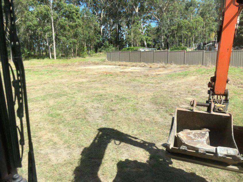 An Excavator is Digging a Hole in the Grass in a Field — Bennettron Demex in Corindi Beach, NSW