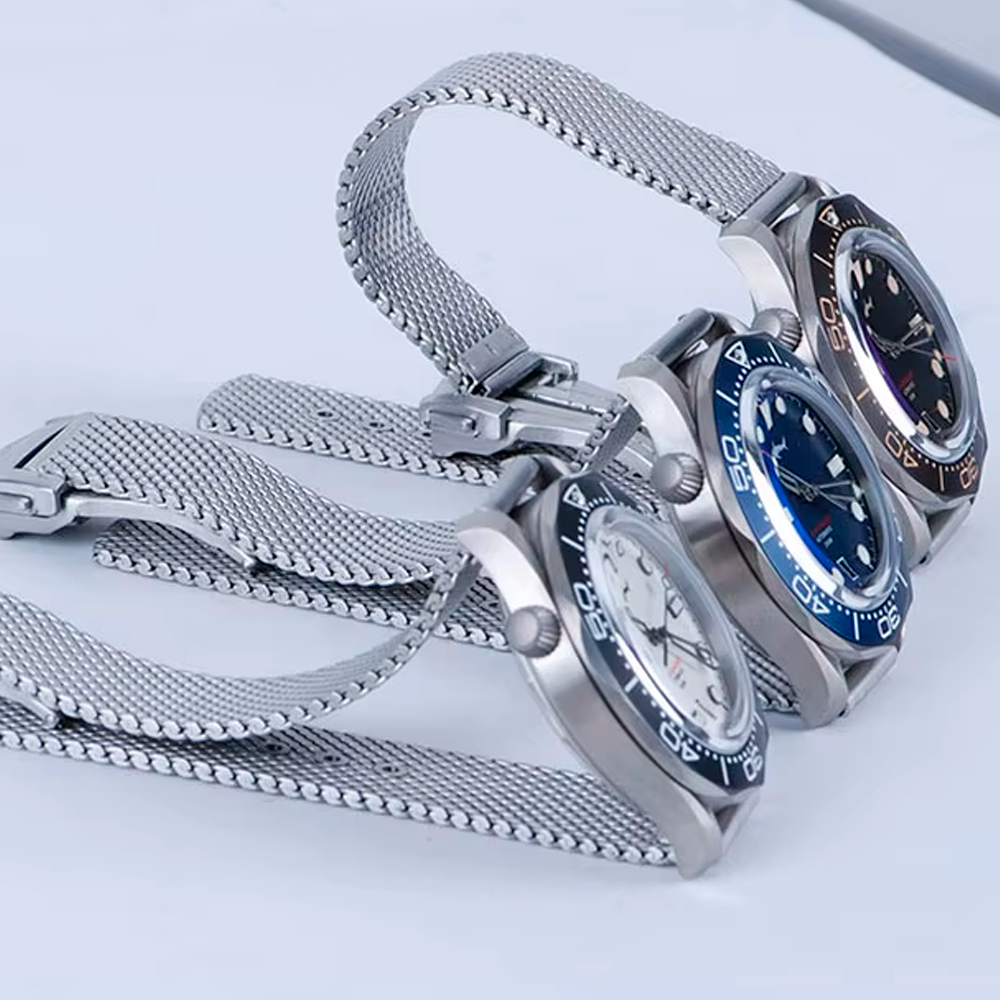 Three watches are stacked on top of each other on a table