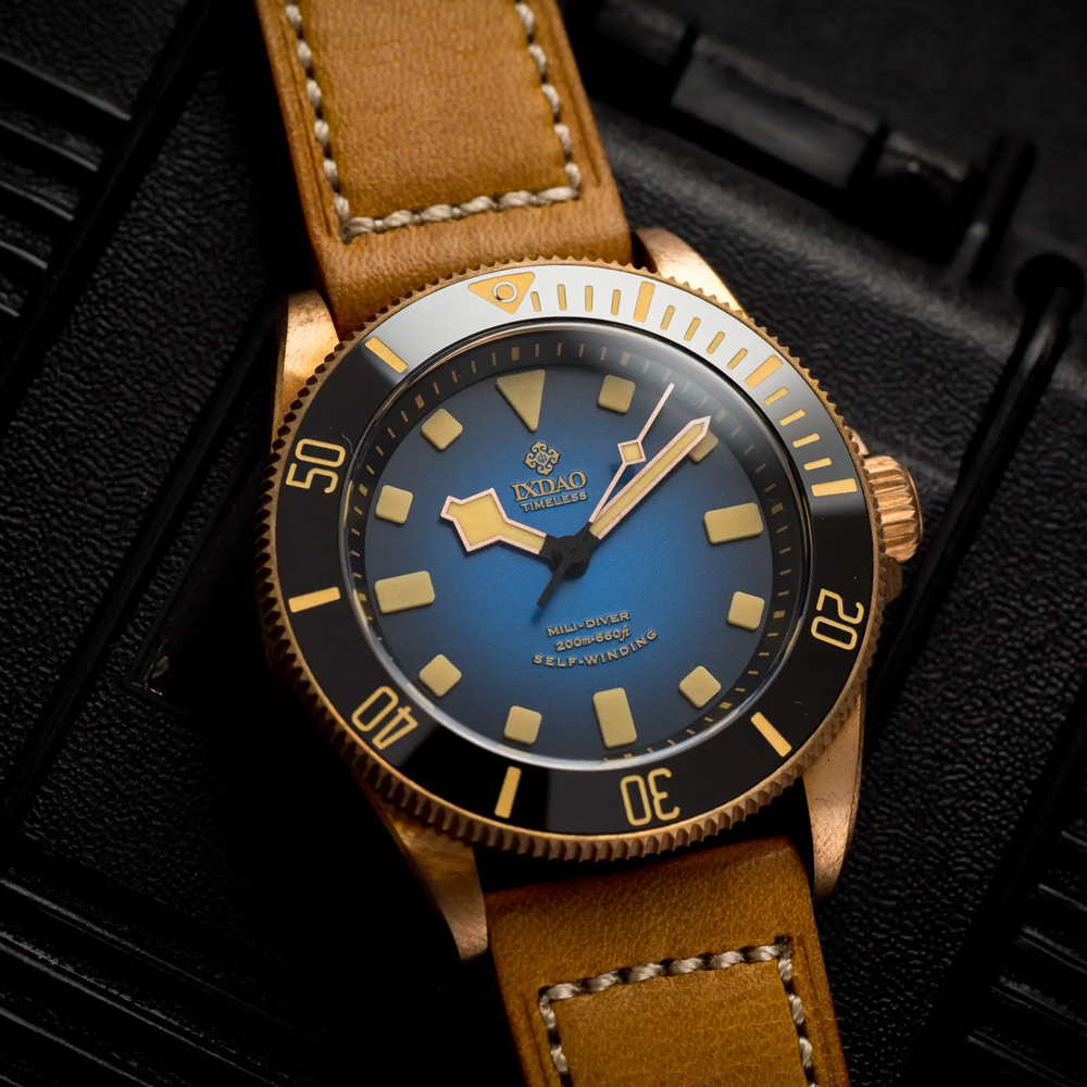 A watch with a brown leather band and a blue face