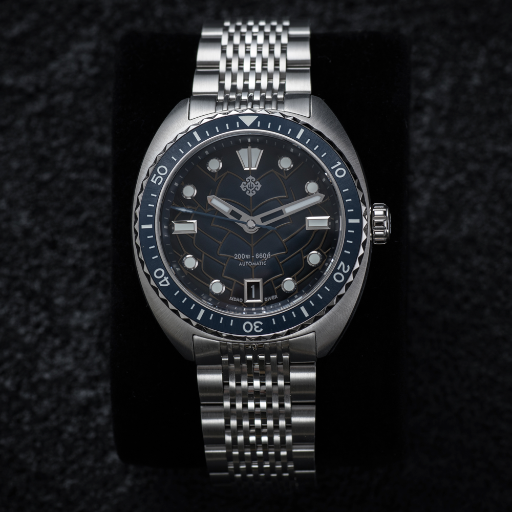 A silver watch with a black face and silver band