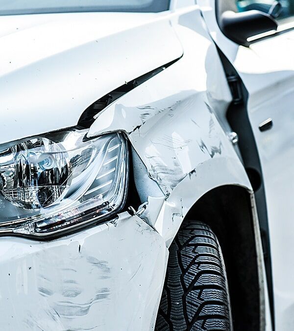 White Car With Severe Front Fender and Headlight Damage From a Collision — Walker Bros. in Casino, NSW