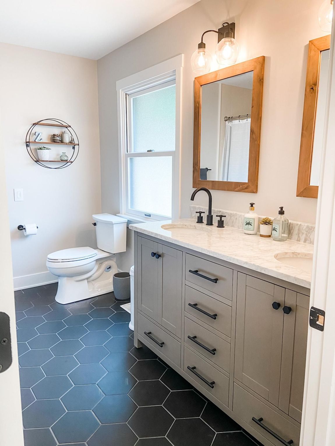 a bathroom with a toilet , sink and mirrors .