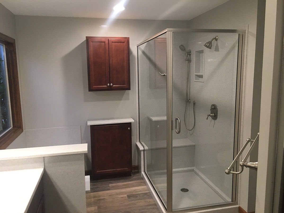 a bathroom with a walk in shower and a sink .