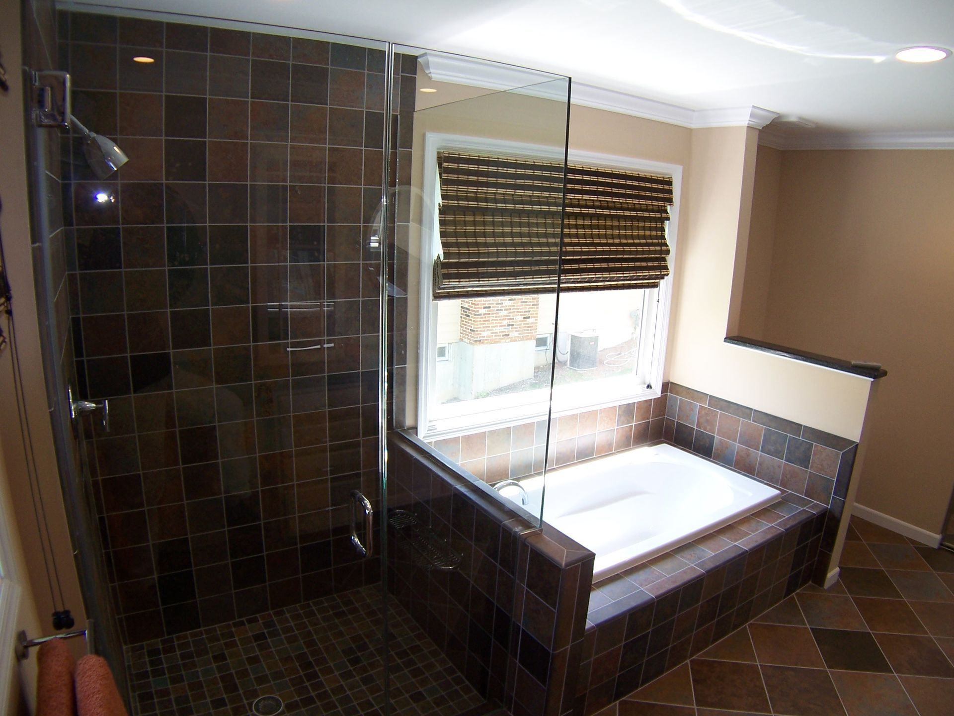 a bathroom with a tub and a walk in shower