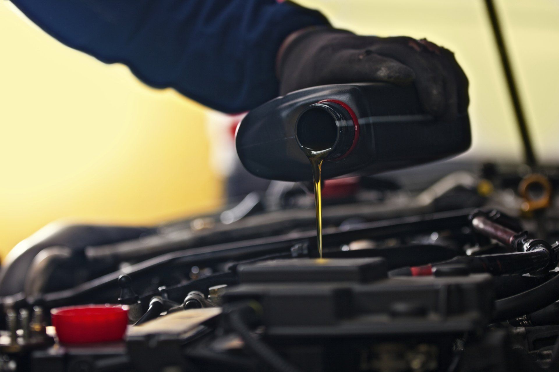 Mechanic Pouring Oil - Lubbock, TX - Wrench 'Em Auto & Diesel Repair Mechanic Pouring Oil - Lubbock, TX - Wrench 'Em Auto & Diesel Repair