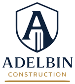 Adelbin Construction logo with navy shield and stylized A above company name on a light background