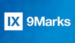 A blue logo featuring a white square containing the blue Roman numerals