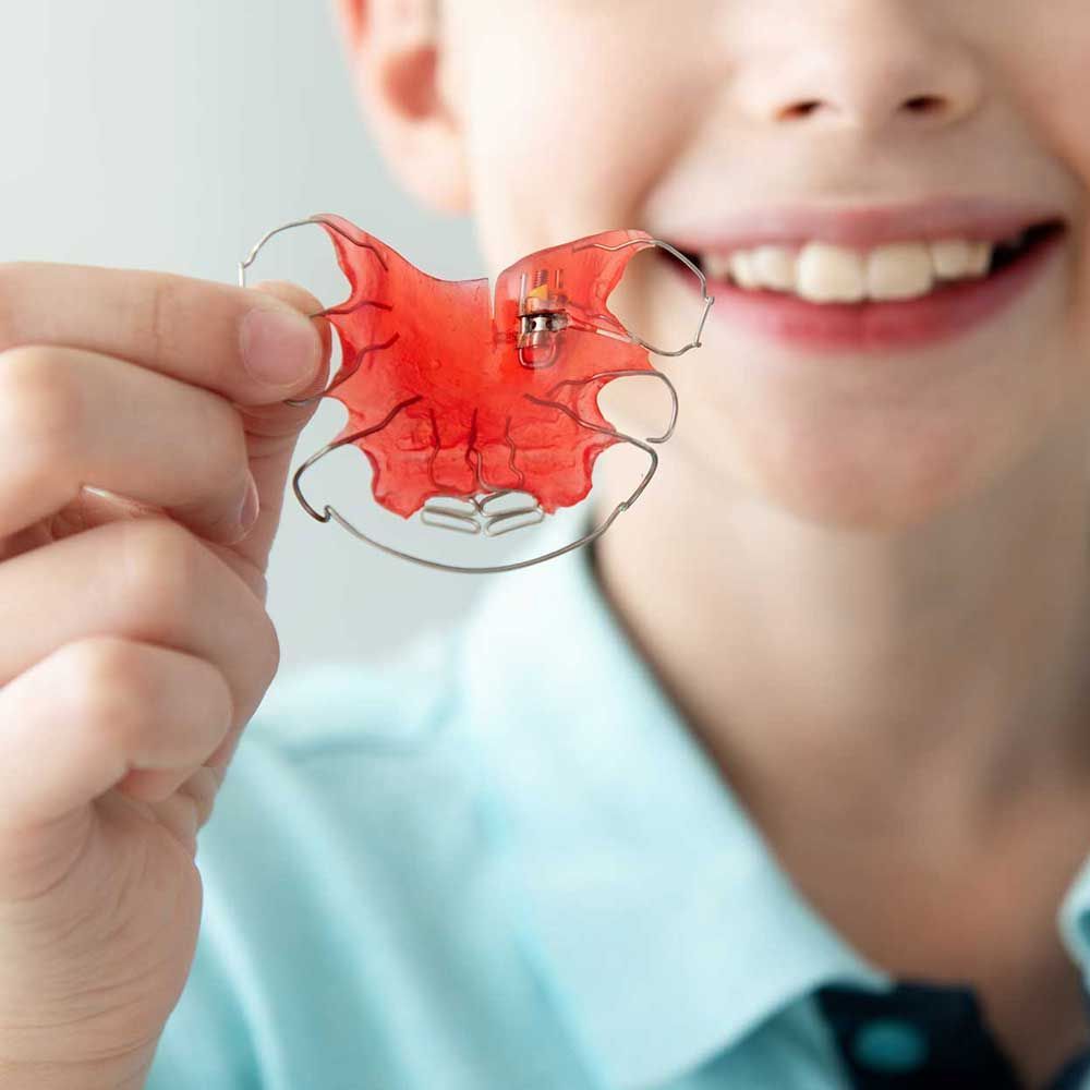 Happy smiling boy with dental braces