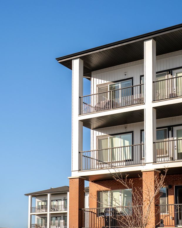 Modern apartment building with balconies and a blue sky background