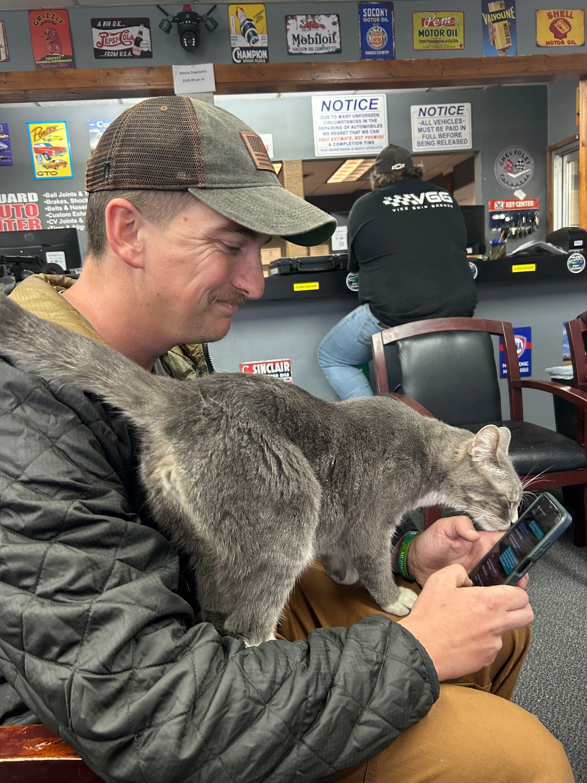 Customer Sitting With Shop Cat In Waiting Area | Lifeguard Tire and Auto