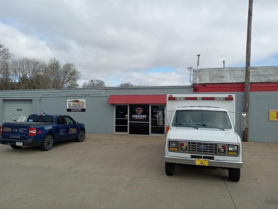 Lifeguard Tire And Auto Shop Exterior With Service Vehicles | Lifeguard Tire and Auto