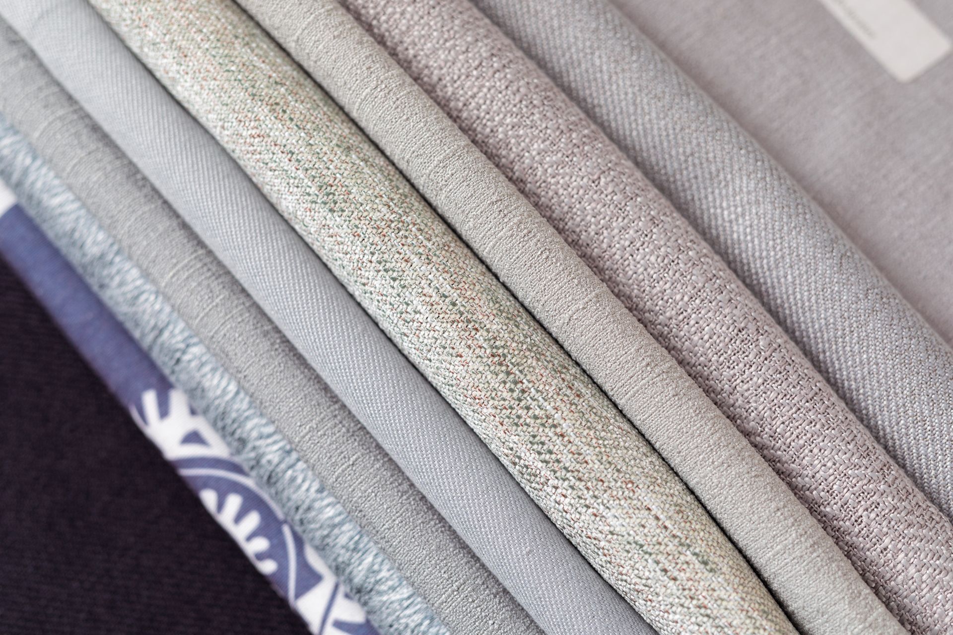 A close up of a stack of different colored fabrics.