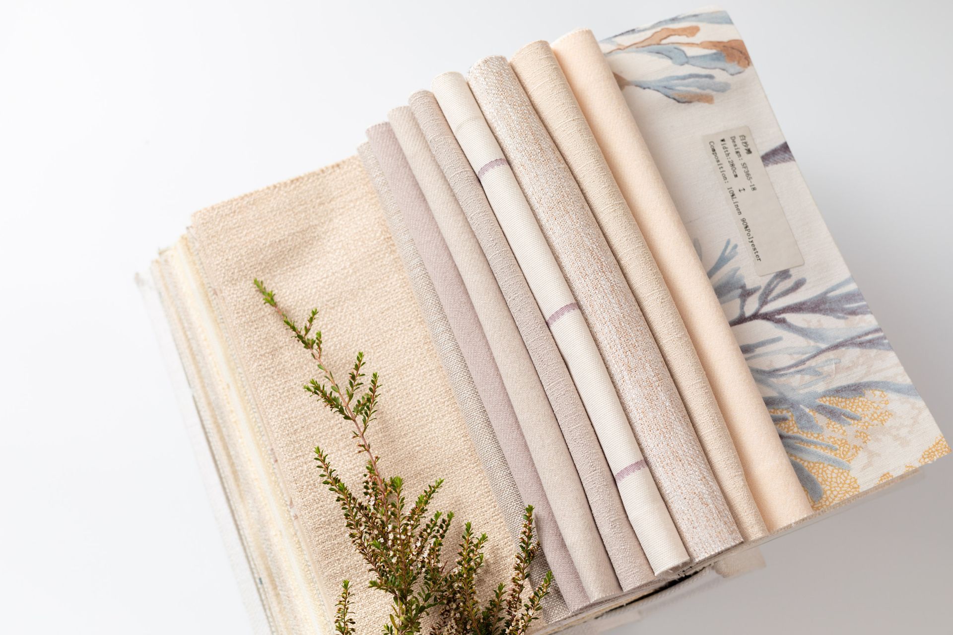 A bunch of fabrics are stacked on top of each other on a table.