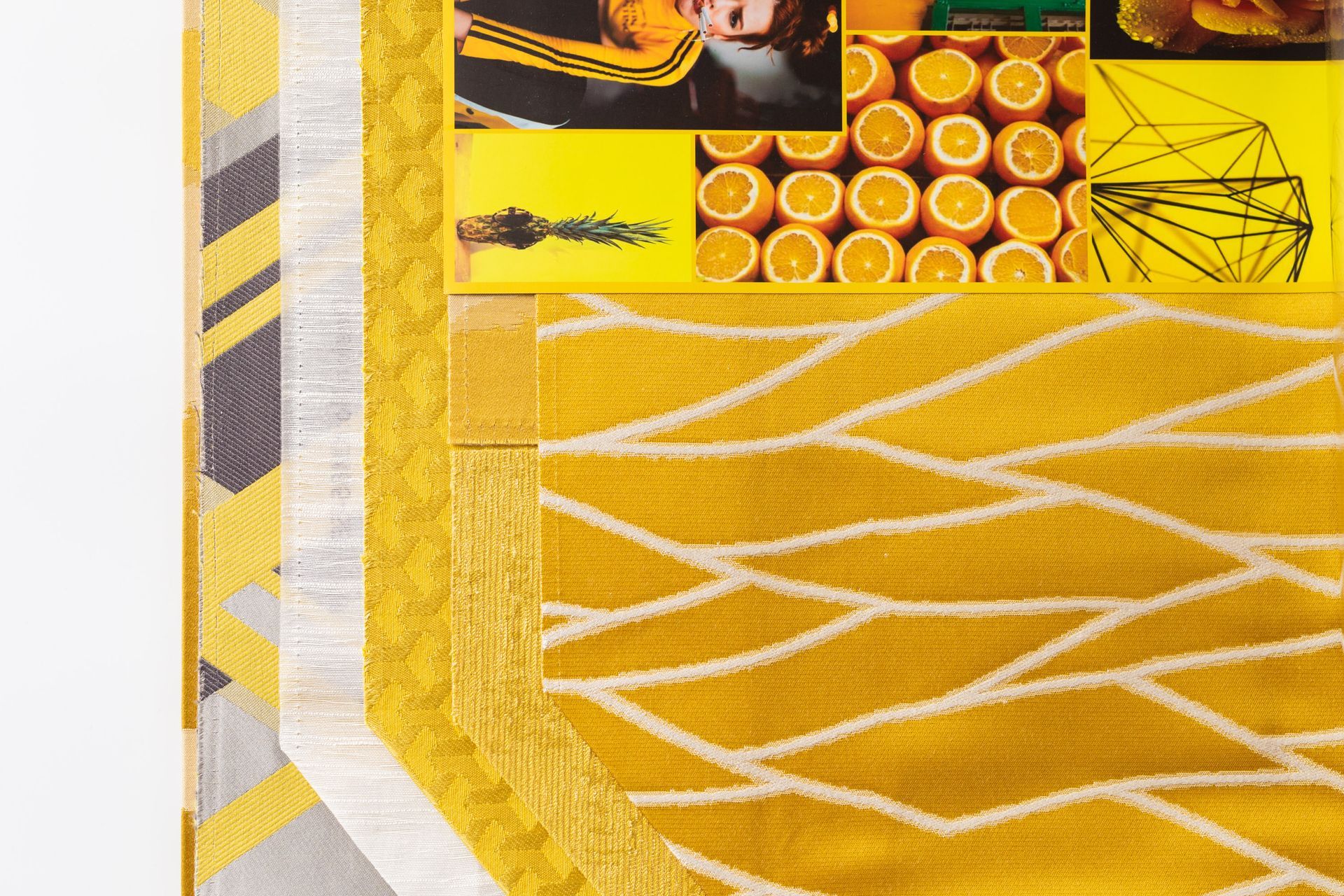 A yellow and white rug with a geometric pattern on it