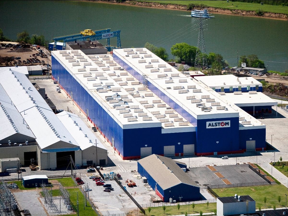 An aerial view of a large blue and white building that says alltor