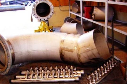 A bunch of metal pipes are laying on the floor