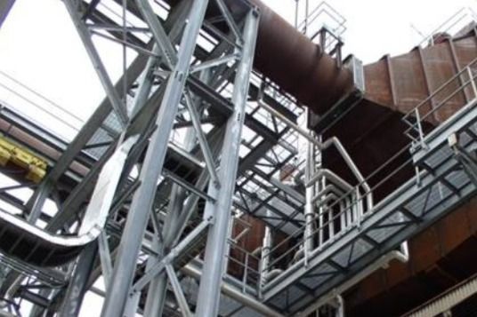 A large metal structure with stairs leading up to it