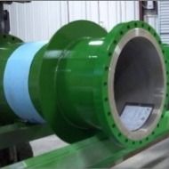 A close up of a green pipe with a blue tape on it.