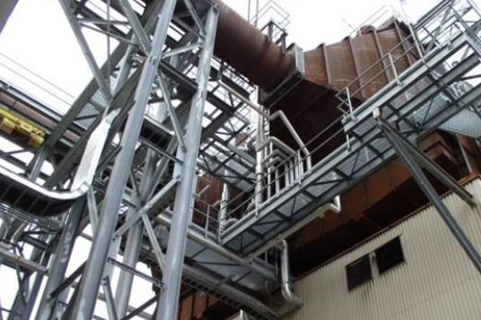 A large metal structure with stairs leading up to it.