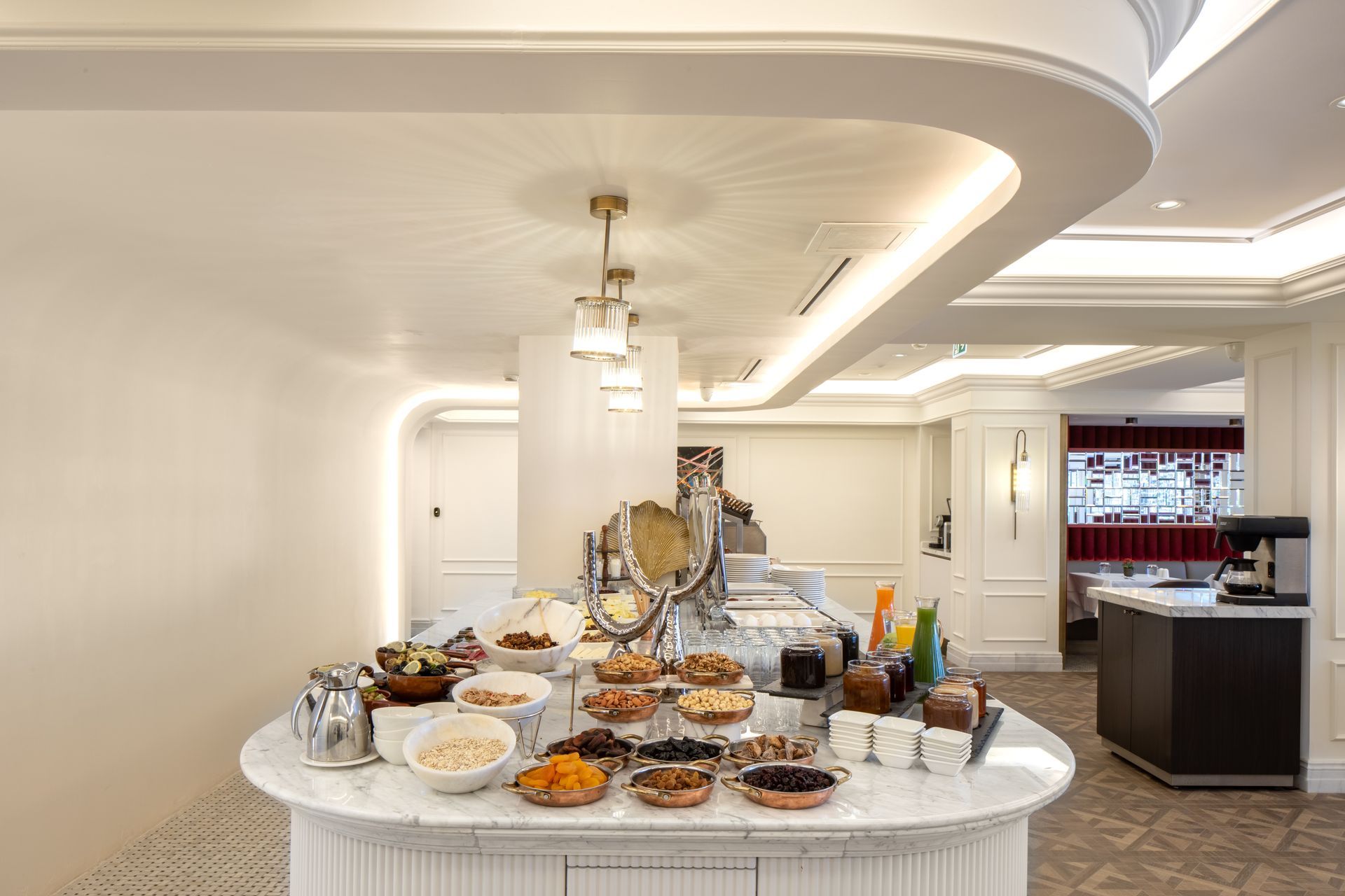 Elegant buffet spread on a white island table in a bright, modern interior room