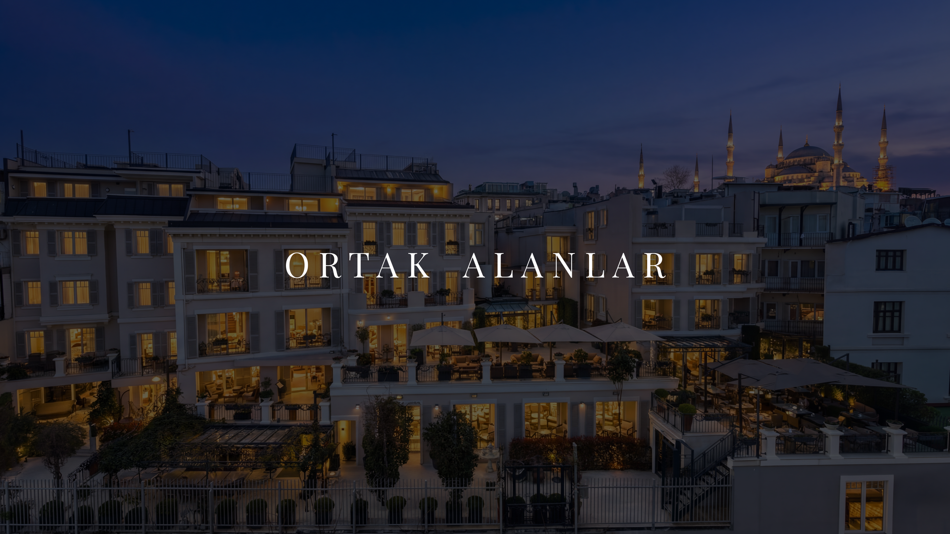 Aydınlatılmış apartman binaları ve ortasında aydınlatılmış 