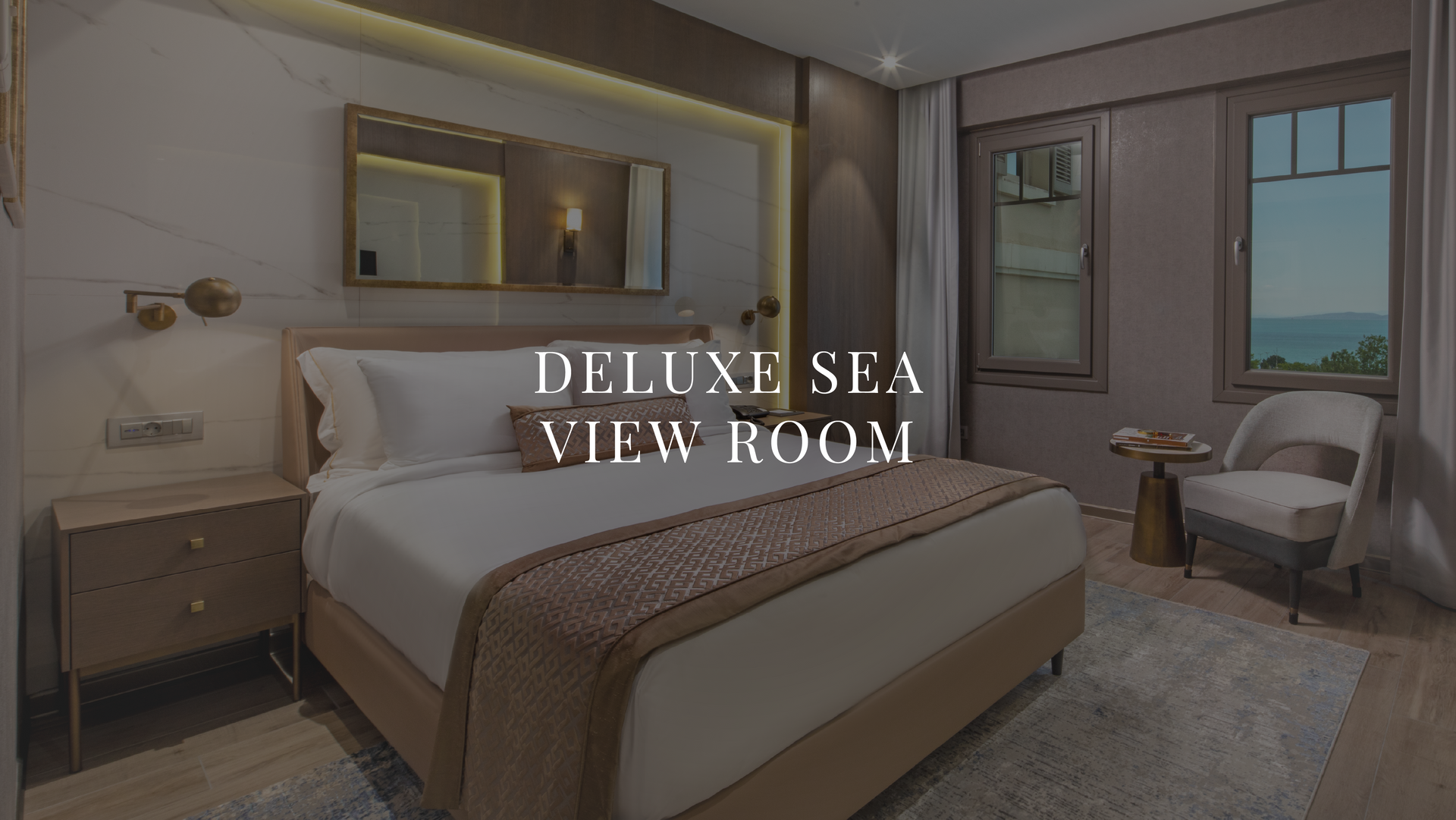 Luxury bedroom with king bed, beige decor, and balcony view of the sea