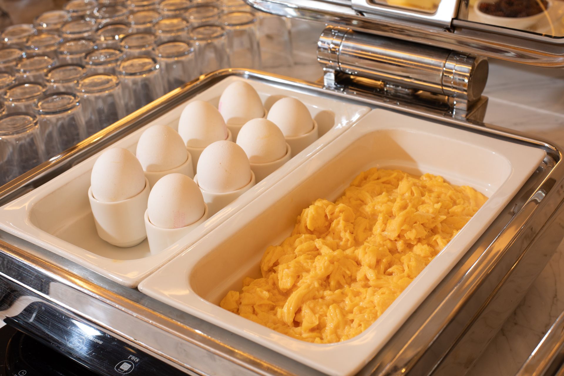 Mula Hotel | Breakfast buffet with hard-boiled eggs in holders and scrambled eggs in a warming tray.