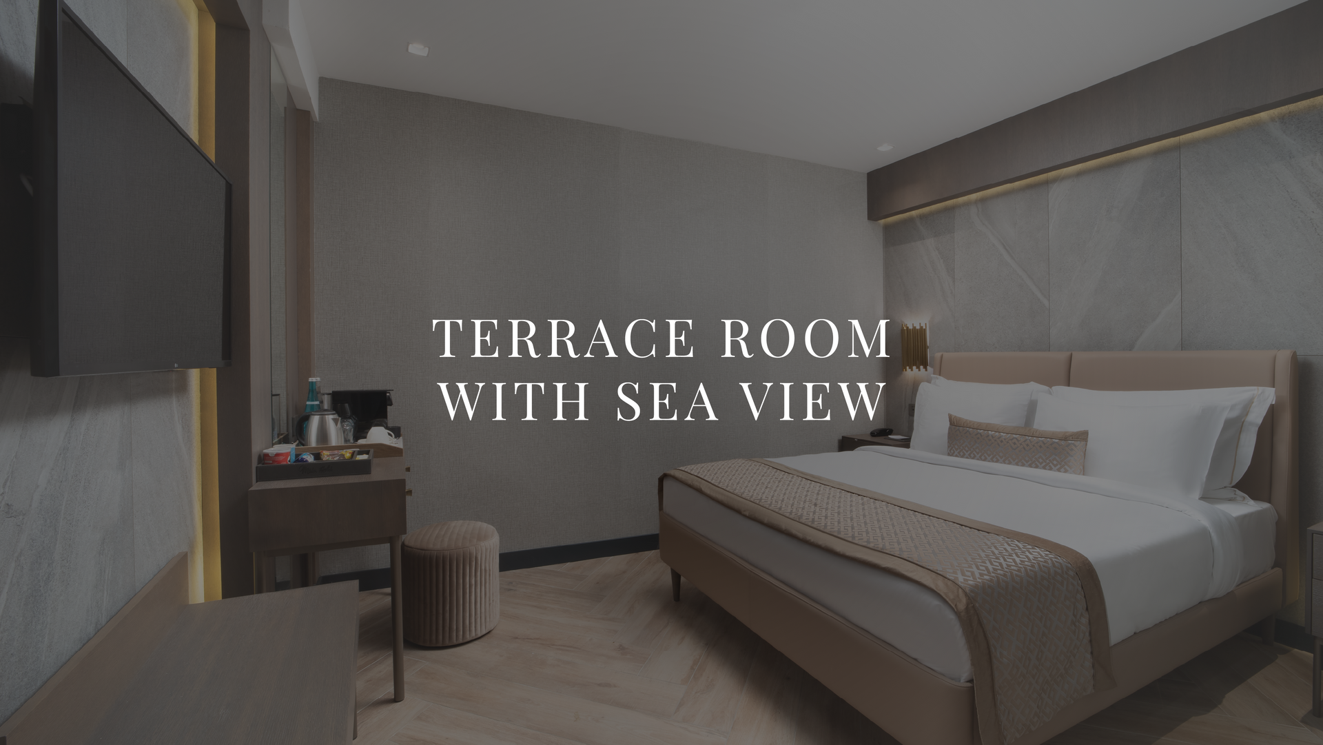 Terrace room with sea view, featuring a modern bed, gray walls, and large windows