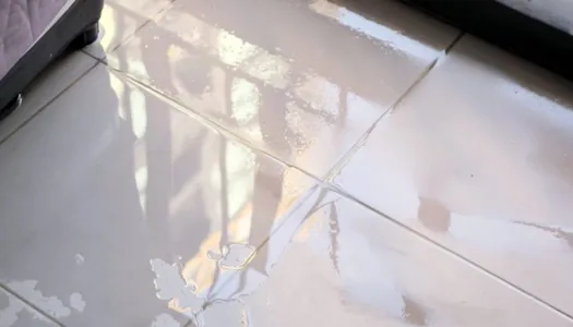 White sink with running water flowing into the drain.