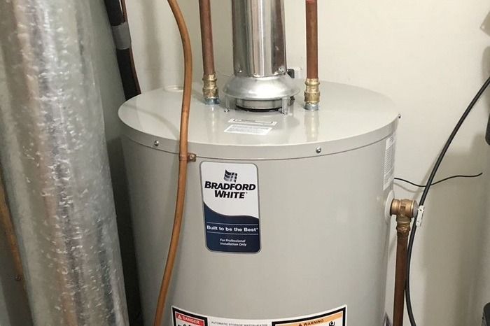 Water heater with pipes in a utility closet