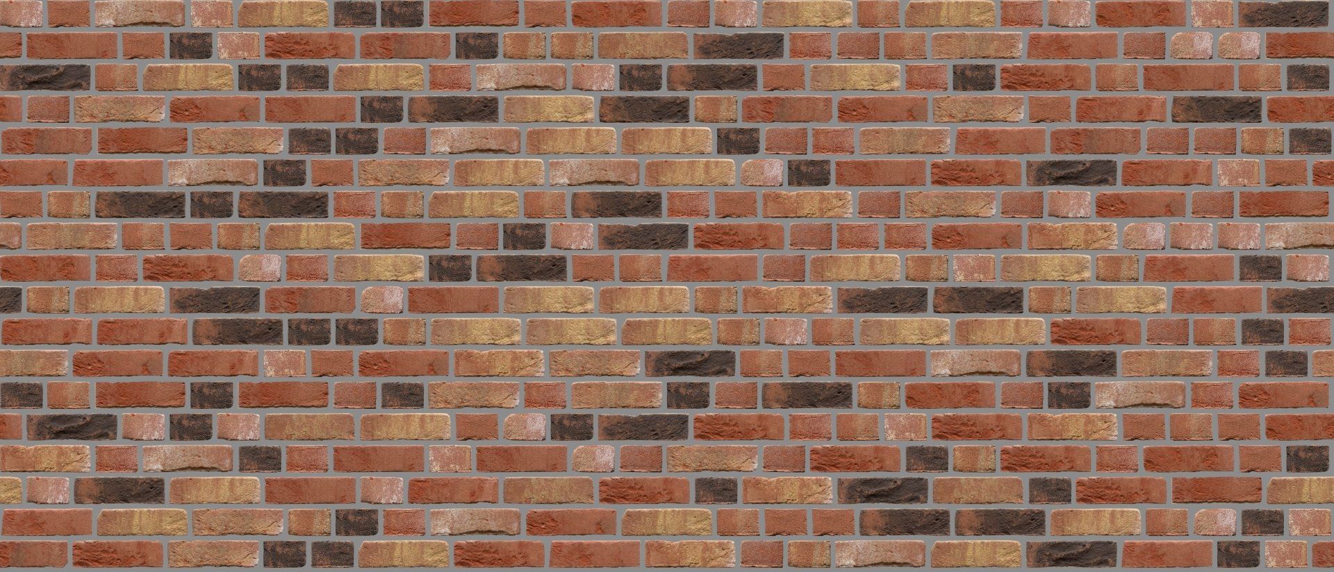 Brick wall with varying shades of red, brown, and yellow.