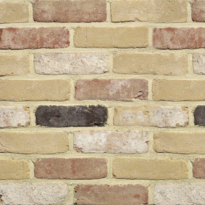 Brick wall with tan, red, and brown bricks.