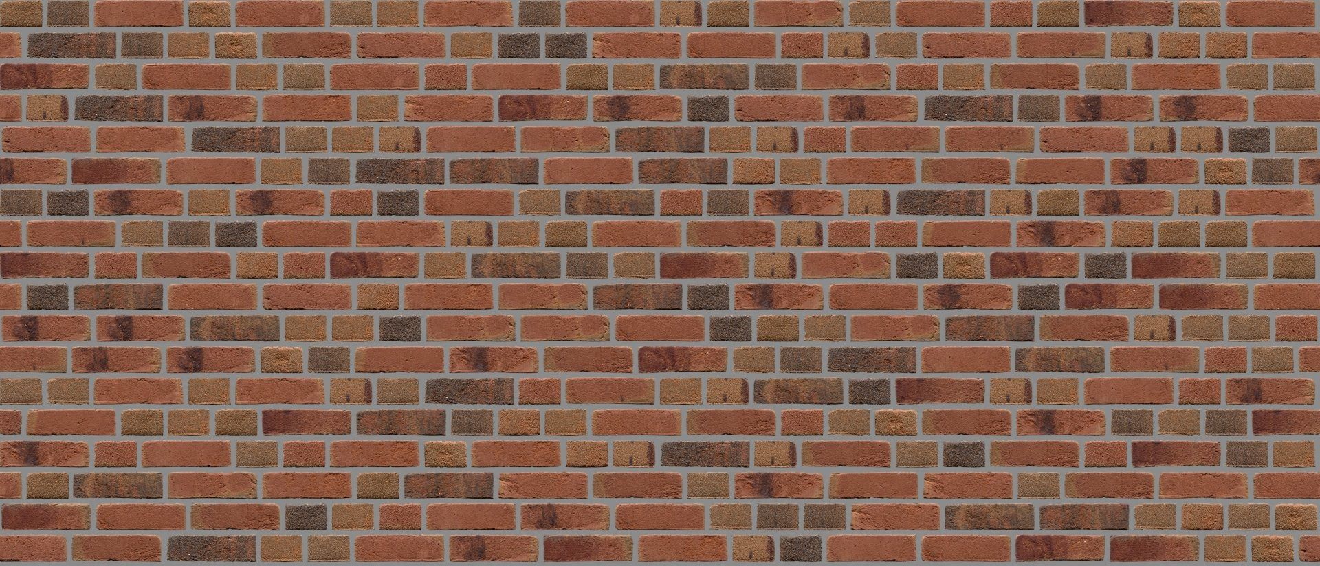 Red brick wall with varied shades of brown and gray.