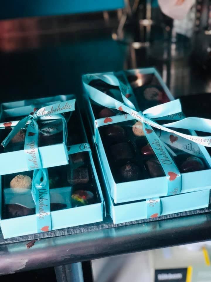 Wedding favour box of handmade bonbons, lid open, ribbon detail