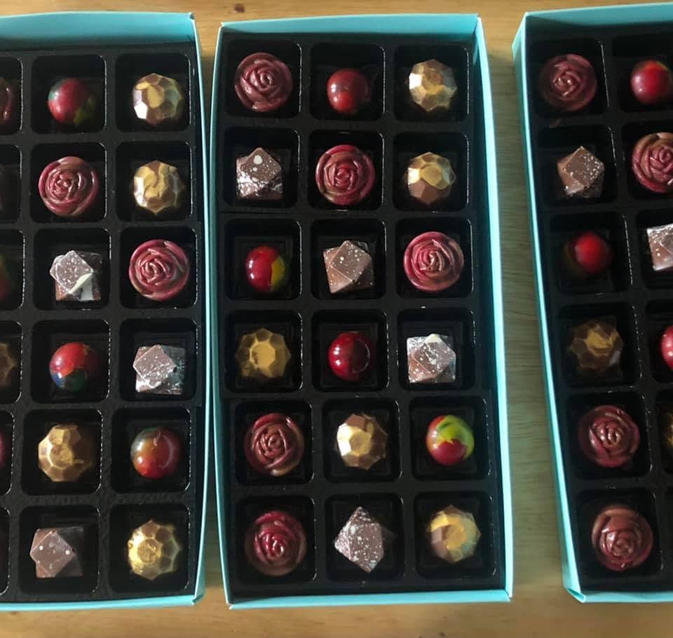 Bespoke selection box open flat showing interior arrangement of mixed chocolates