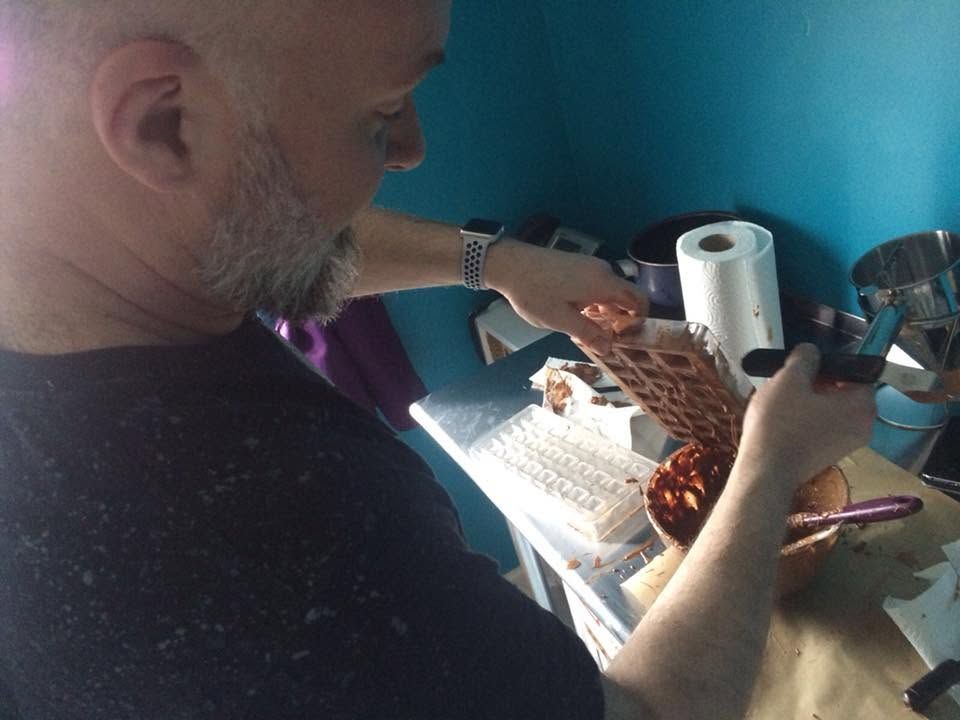 Placeholder for original Chokoholic photography showing hands working chocolate into moulds
