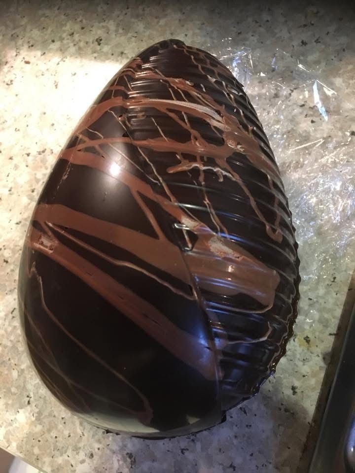 Bespoke Easter egg with hand-decorated exterior and tied packaging