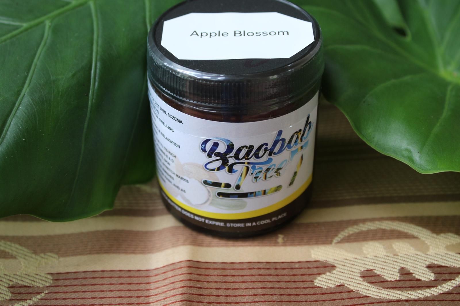 Jar of Baobab Bliss supplement on a patterned cloth, framed by green leaves